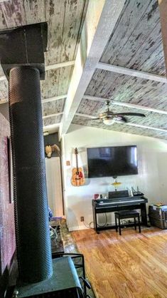 a living room filled with furniture and a flat screen tv mounted on the wall next to a fireplace