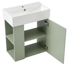 a white sink sitting next to a green cabinet with two shelves on each side and a faucet in the middle