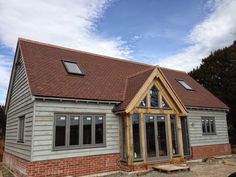 a house that is being built with brick and wood