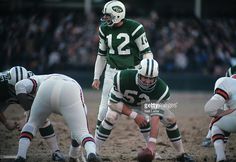 a group of football players standing on top of a field next to each other during a game