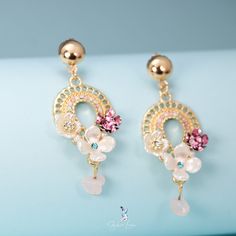 These gorgeous bohemian flower dangle drop earrings feature beautiful crystal and resin flower on bohemian design dangle drop with colored crystal gemstones, this pair of flower drop earrings will elevate your outfit and make you shine at the party. Add these beautiful bohemian flower drop earrings to your everyday party fashion earrings collection or as gift for your love one. Materials: alloy, rhinestone, resinFinish: gold color Jewelry Care: See more information about how to care for your jew Floral Print Flower Jewelry For Parties, Elegant Floral Print Earrings For Spring, Elegant Spring Flower Earrings With Floral Print, Elegant Floral Print Flower Earrings For Spring, Elegant Floral Print Earrings, Bohemian Flower Charm Drop Earrings, Bohemian Jeweled Crystal Dangle Earrings, Bohemian Crystal Drop Earrings, Elegant Floral Print Drop Earrings