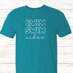 a turquoise shirt with white letters that say swim, swim and swim on the front