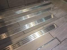 stainless steel grates are lined up on the floor