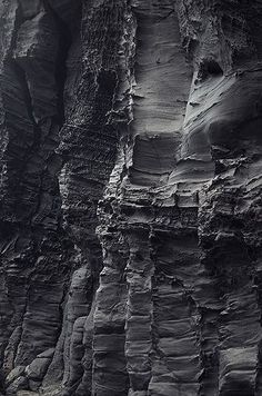 black and white photograph of rock formations in the ocean