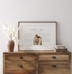 a wooden dresser topped with drawers and a framed photo