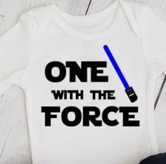 Baby boy 1st birthday One with the force top with light sword in your color choice.    Light sword color choices: purple, red, yellow, green, pink or blue.  Long or Short sleeve Bodysuit sizes: newborn, 3M 6M 9M 12M 18M 24M Tshirt Sizes 2T 3t 4t 5 Find my shop here: https://www.etsy.com/shop/APocketfulofBows BODYSUIT/TEE SHIRT CARE Turn inside out before washing Cold water/Gentle cycle No fabric softener  Lay flat to dry Do not iron on design Listing Photographs: Photos shown on the listing are 1st Birthday Boy Star Wars, Star Wars First Birthday Outfit, One With The Force First Birthday, Star Wars 1st Birthday Shirt, Its My First Birthday Onesie Boy, Lightsaber Colors, Cake Smash Inspiration, Birthday One, Star Wars Shirts