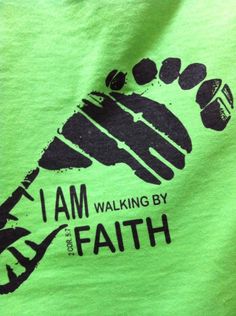 i am walking by faith t - shirt in green with black print on the chest