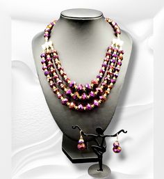 "Purple Radiance": This Purple Radiance Necklace illuminates any neckline with vibrant, iridescent color. Crafted from sparkling, jewel-inspired stones, this piece is sure to become a conversation starter, infusing your ensemble with luminous charm and grace. Necklace is approximately 19" with extender. Elegant Purple Jewelry Set For Festive Occasion, Purple Round Beads Jewelry For Festive Occasion, Purple Beaded Jewelry For Festive Occasions, Purple Crystal Necklaces For Party, Purple Costume Jewelry For Party, Iridescent Adjustable Necklace For Party, Purple Faceted Beads Jewelry For Party, Purple Round Beads Jewelry For Party, Purple Jewelry With Faceted Beads For Party