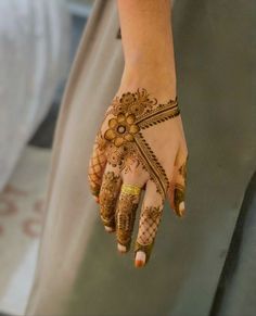 a woman's hand with henna on it