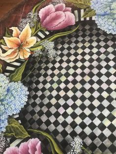 a painting of flowers on a black and white checkered table cloth