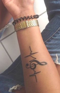 a woman's arm with a tattoo on it and the word love written in cursive writing