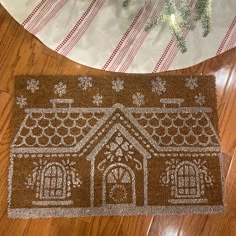 a door mat with a gingerbread house on it