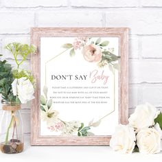 a sign that says don't say baby next to some flowers and a mason jar