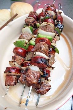 the skewers are being cooked on the plate