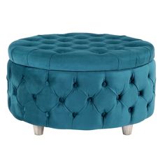 a blue ottoman with wooden legs and buttons on the top, sitting in front of a white background