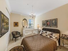 a bedroom with a large bed and pictures on the wall