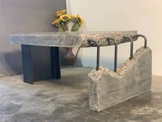 a bench made out of concrete with iron bars attached to it