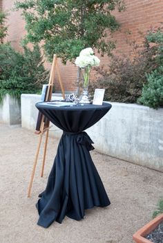 a table with a black cloth draped over it