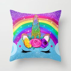 a pillow with a unicorn's face and flowers on it