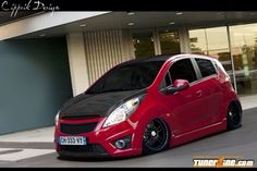 a red car parked in front of a building