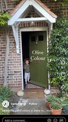 a little boy standing in front of a green door with the words olive colour on it