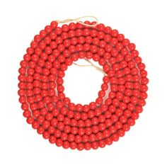 red beads are arranged on a white background