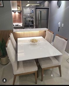 a white table with four chairs around it