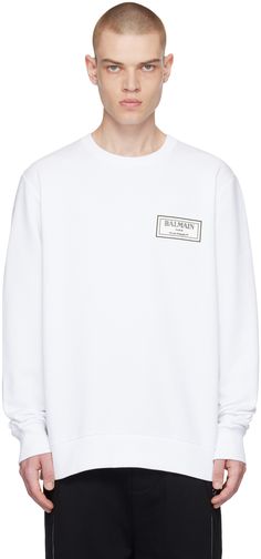 GOTS-certified organic cotton French terry sweatshirt. · Rib knit crewneck, hem, and cuffs · Rubberized logo patch at chest · Logo printed at back Supplier color: Optic white White Logo Patch Sweatshirt For Streetwear, White Long Sleeve Tops With Logo Patch, White Long Sleeve Top With Logo Patch, White Cotton Sweatshirt With Logo Patch, White Cotton Logo Sweater, White Logo Patch Sweatshirt, White Long Sleeve Sweatshirt With Logo Patch, White Long Sleeve Sweater With Logo, White Sporty Sweater With Logo