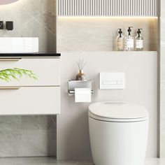 a white toilet sitting in a bathroom next to a sink and vanity with a mirror above it