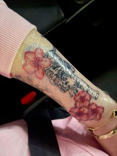 a woman's arm with flowers on it