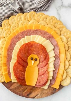 a turkey and cheese platter with crackers on the side