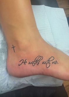 a person with a tattoo on their foot that says,'he wrote with me '