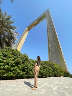 a woman standing in front of a tall building