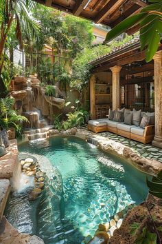 an outdoor swimming pool surrounded by greenery and stone steps leading up to a covered patio