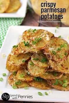 crispy parmesan potatoes on a white plate with green onions in the background