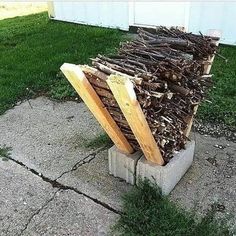 a pile of wood sitting on top of a cement block