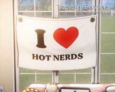 i love hot nerds banner hanging on the window sill in front of an open window