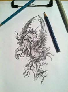 a pencil drawing of a winged unicorn on paper