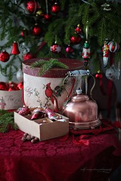 a christmas tree is decorated with red and green ornaments, including an old fashioned coffee pot