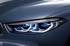 the front lights of a blue bmw car