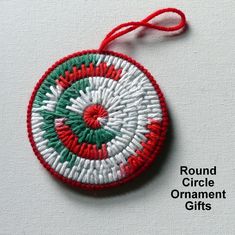 a round ornament hanging from a red string