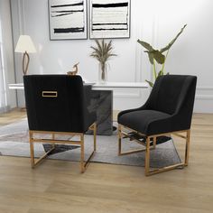 two black chairs sitting next to each other on a wooden floor in front of a white wall