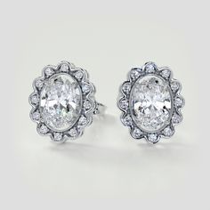 pair of diamond earrings on white background with clippings to the top and bottom