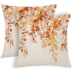 two pillows with orange leaves on them