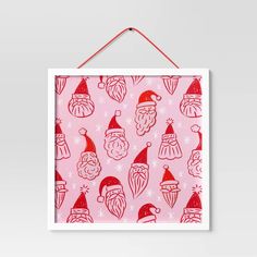 a pink and red christmas pattern hanging on a wall