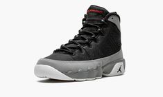 The Air Jordan 9 GS “Particle Grey” is the youth sizing for the simple yet striking take on a fan favorite Air Jordan model.  This Jordan 9 for kids features a black textile base with Particle Grey leather overlays and contrasting red accents for the branding areas on the heel and tongue.  A white rubber outsole completes the design. Air Jordan 9 Retro, Jordan 9 Retro, Air Jordan 9, Jordan Model, Jordan 9, Stadium Goods, Kids Jordans, Grey Shoes, Red Accents