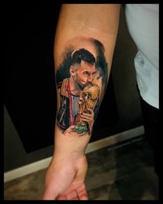 a man with a tattoo on his arm is holding a sandwich and a skull in his hand