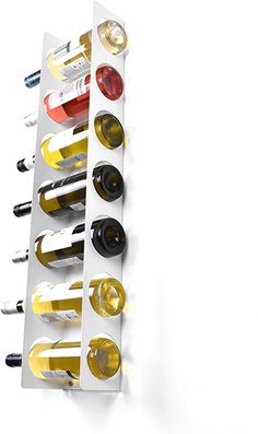 a wine rack with several bottles in it on a white wall next to a bottle opener