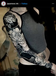 a woman with black and white flowers on her arm