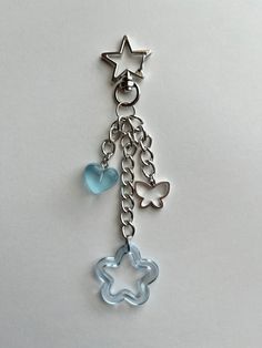 a keychain with a star and heart charm hanging from it's side